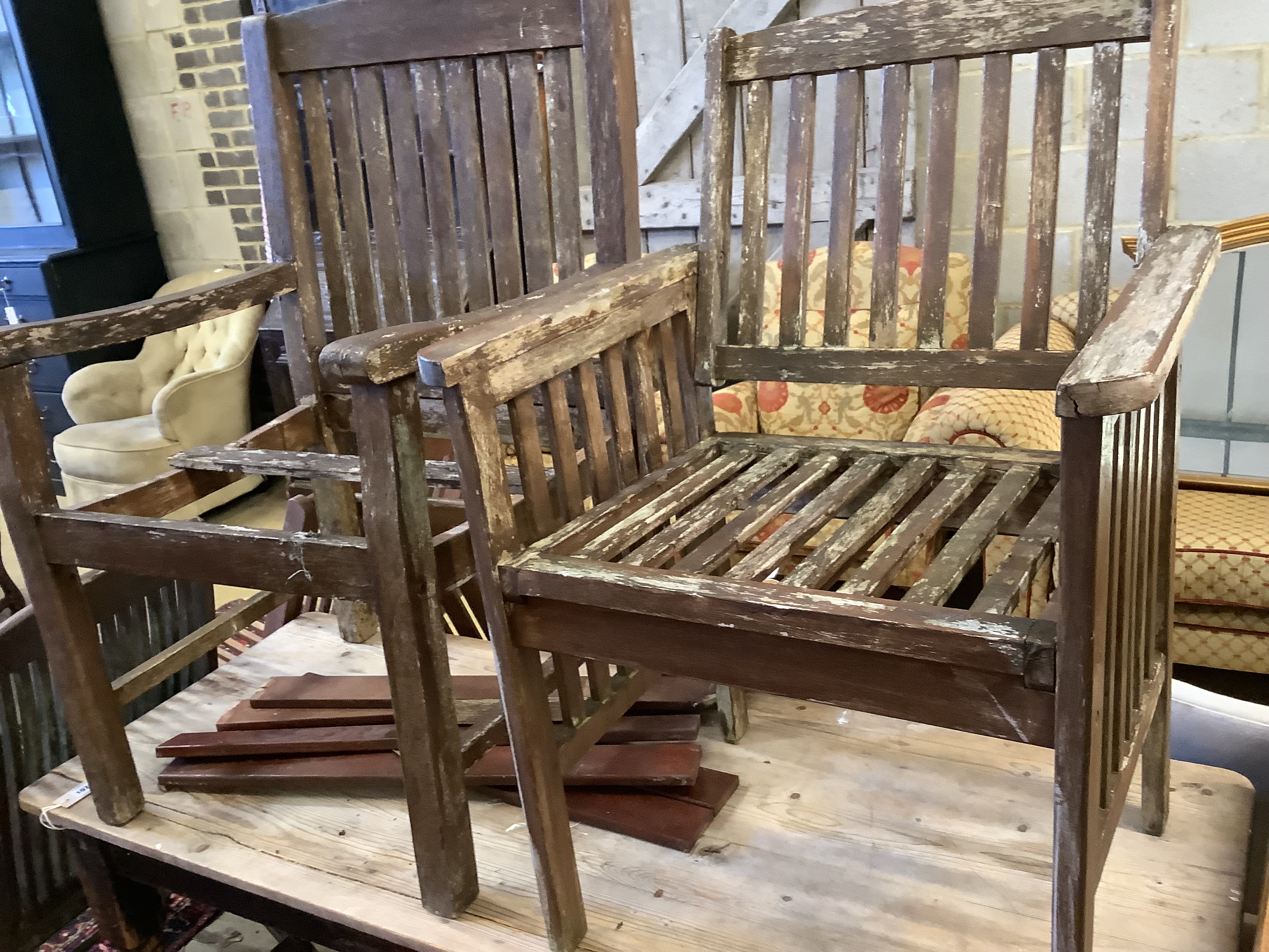 Three various teak folding garden elbow chairs together with two other teak garden chairs